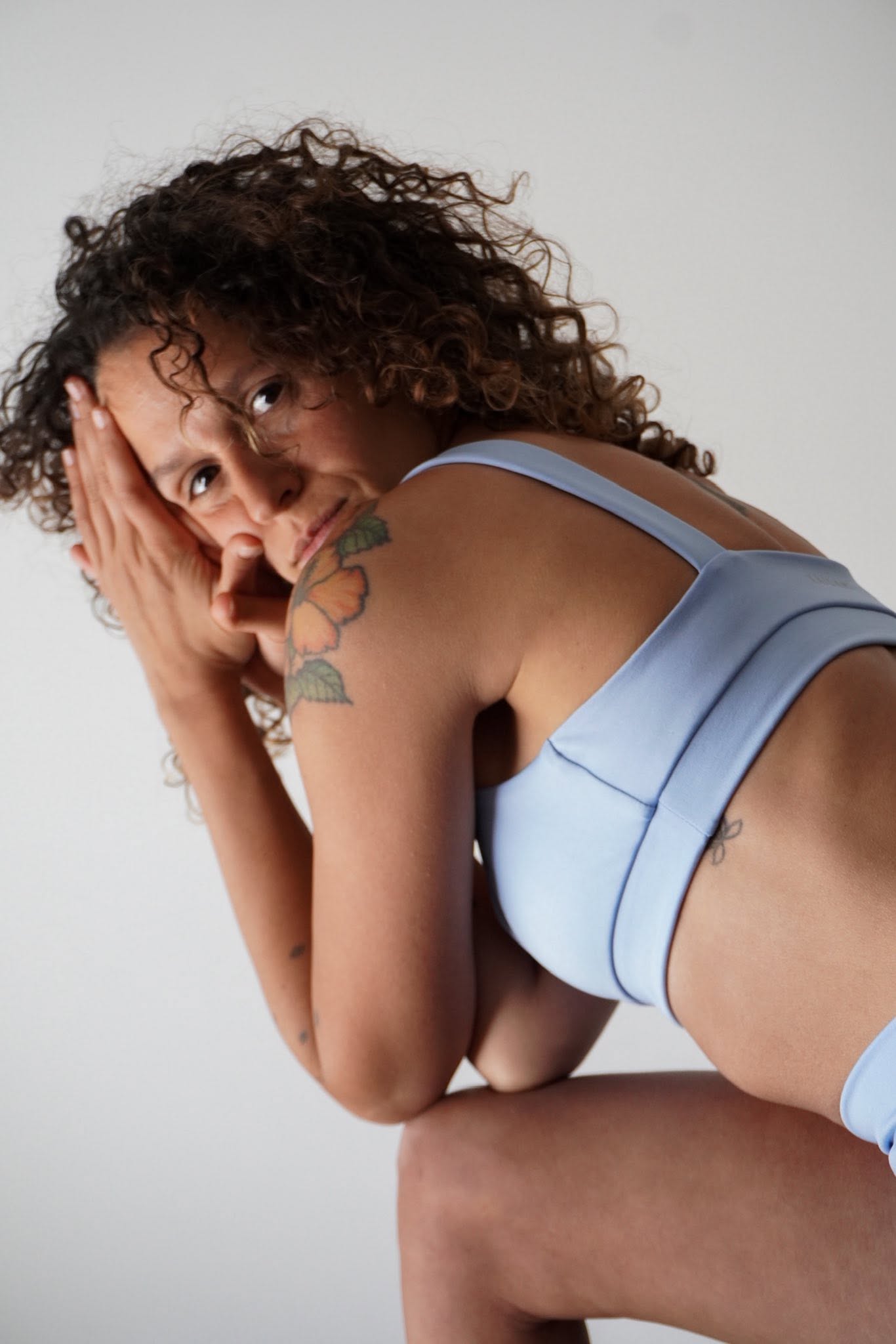 Josefina looking back showing her wildflowers shoulder tattoo